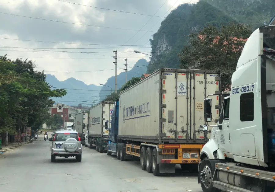 Refrigerated trucks queued at a northern border crossing — a recurring image during China quarantine episodes
