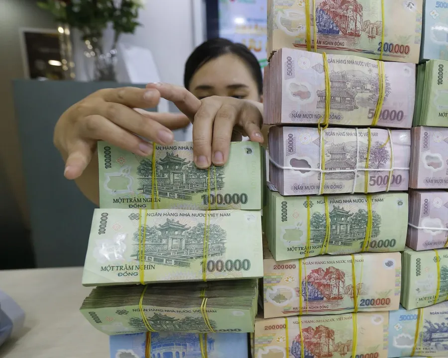 Cash bundles at a bank counter