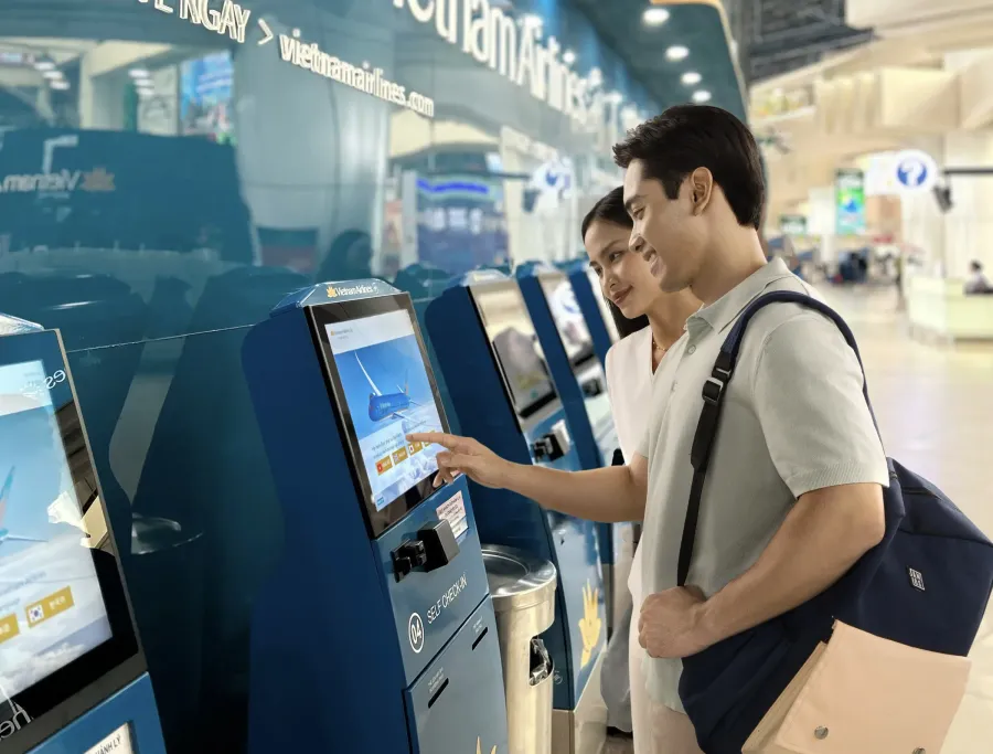 Passengers using Vietnam Airlines self check-in kiosks