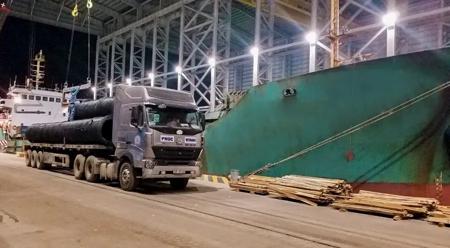 A truck carrying steel from the port area