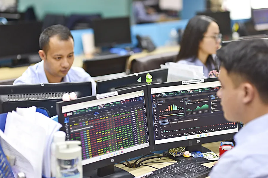 Investors monitor price movements on trading screens