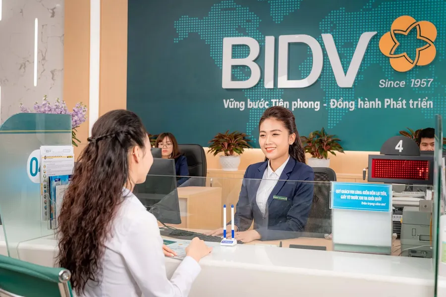 A customer completing a deposit transaction at a bank