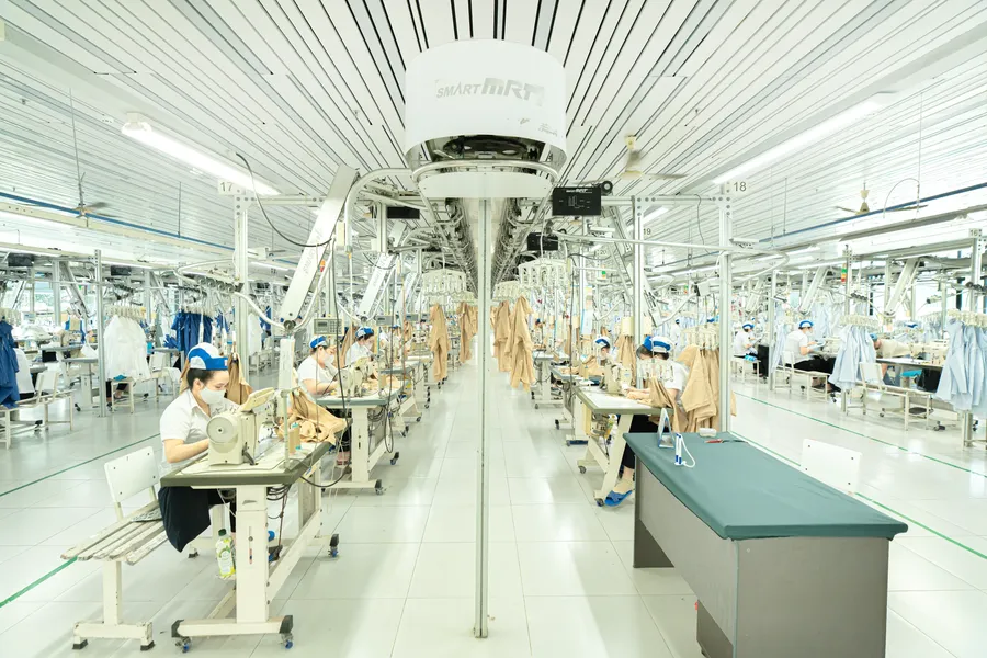 Workers pack export garments at a factory in Vietnam
