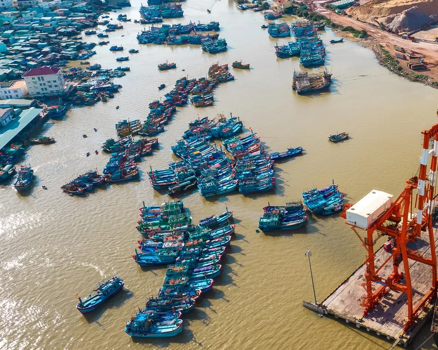 Fishing boats moored at a Vietnamese port, a group bearing the direct diesel cost