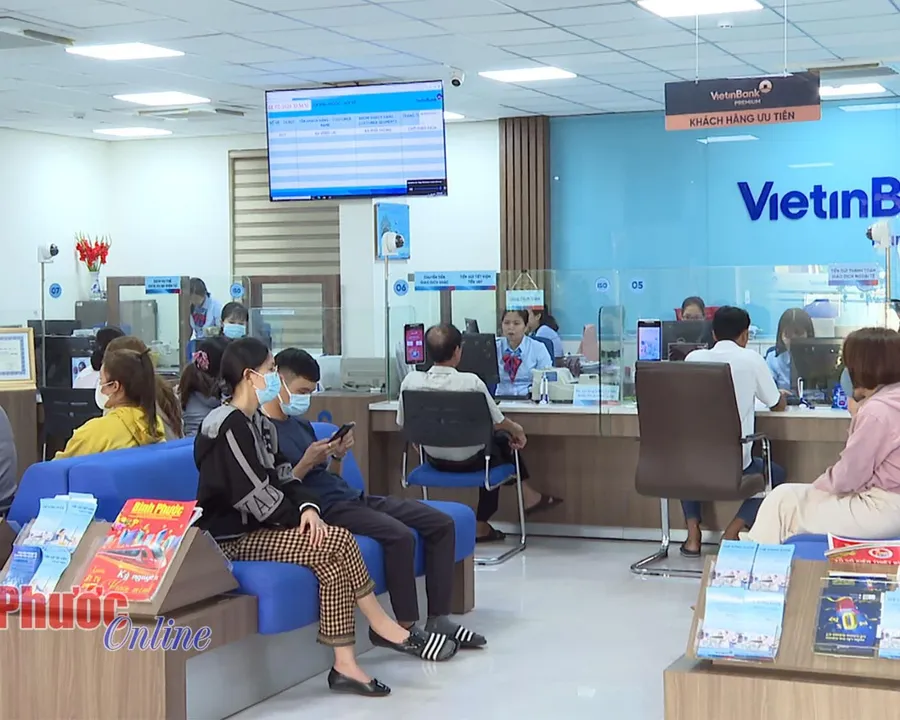 A customer filling out a loan application at a bank branch