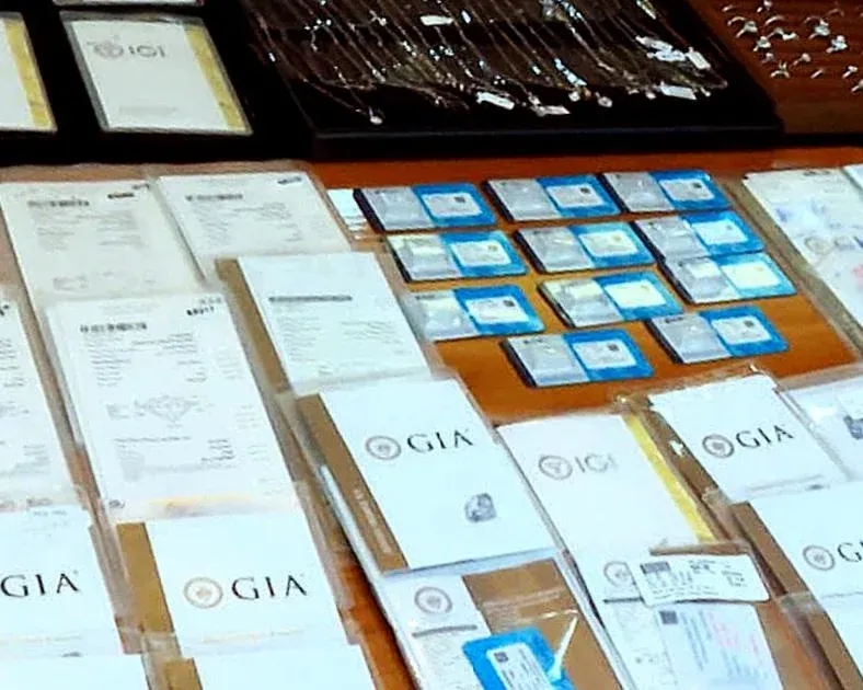 Seized diamonds and appraisal certificates from the smuggling case