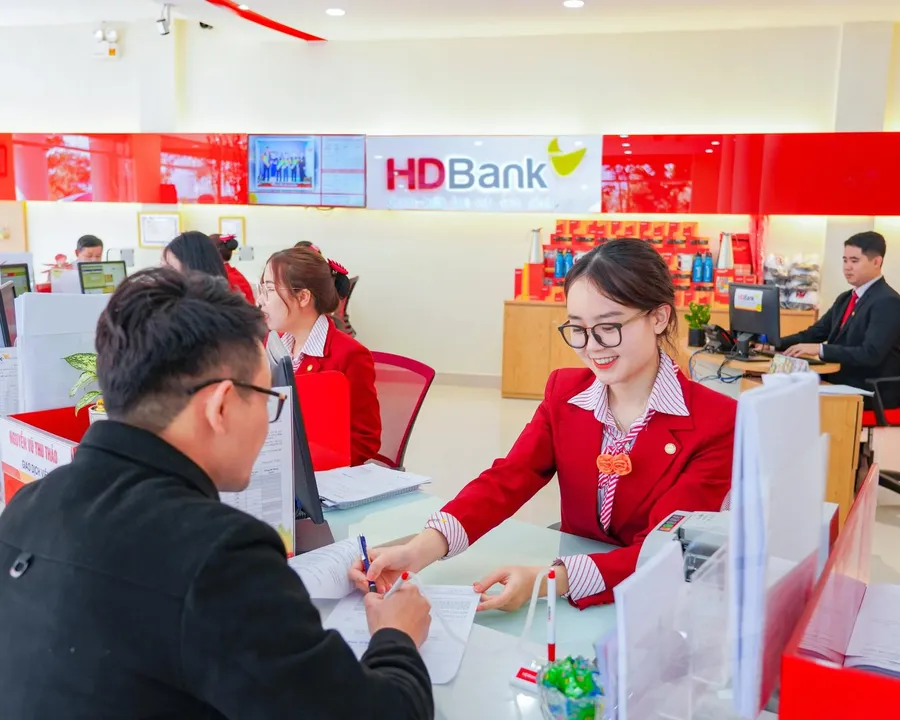 Customer opening a savings account at a bank counter