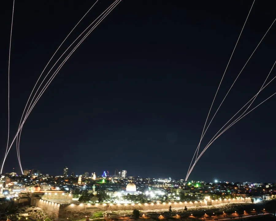 Missile trails and air defense intercepts lighting up the night sky