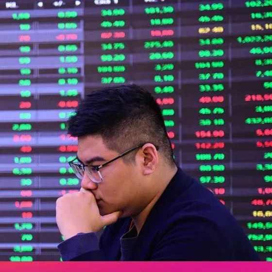 Vietnamese investor watching a stock price board