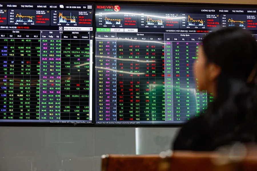 An investor watches a trading board at a securities exchange