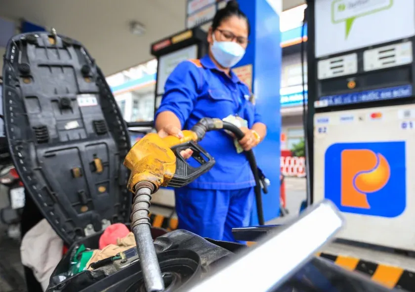 A Petrolimex attendant refuelling a motorbike