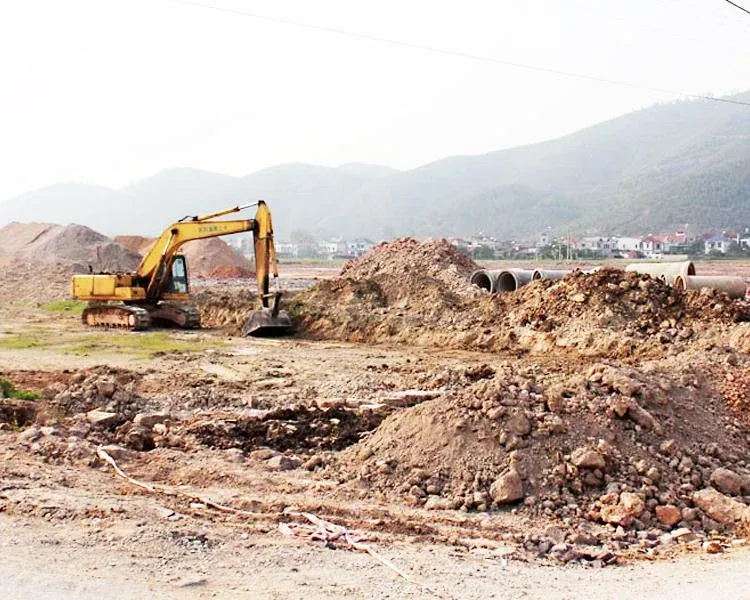 An excavator levelling ground, the stage between signing a land lease and recognising revenue