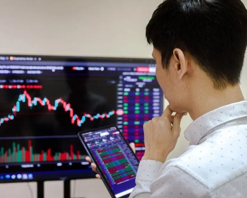 An investor watching price movements on a trading board